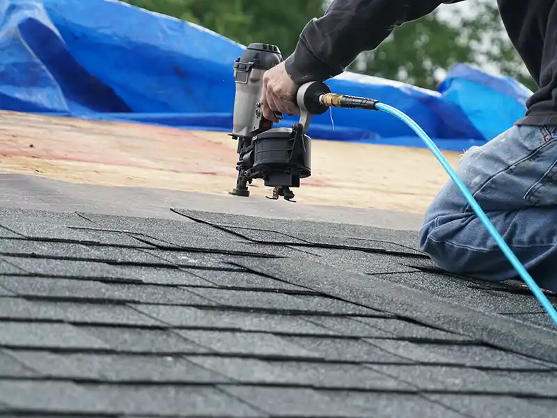 Roofer installing new shingles