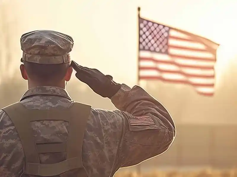 Military personnel saluting the American flag